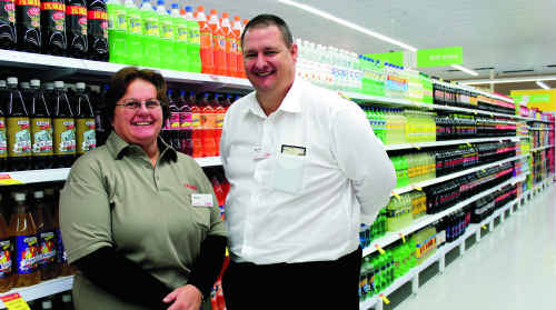 Coles employee Helen Wilson shows off the new store with Emerald Coles store manager Darrin Simpson. Helen said she is looking forward to getting back to normality. Coles employee Helen Wilson shows off the new store with Emerald Coles store manager Darrin Simpson. Helen said she is looking forward to getting back to normality.